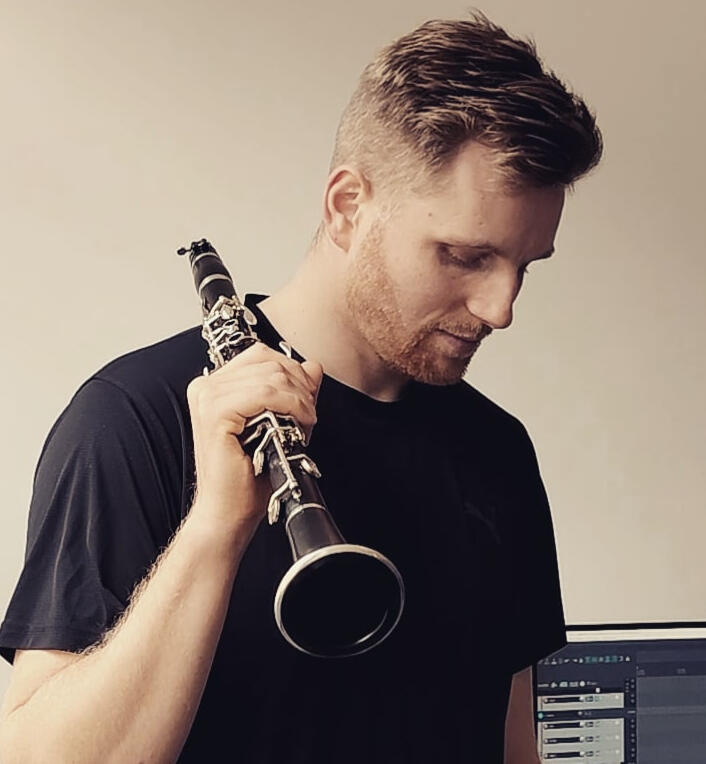 liam headshot liam holding clarinet over his shoulder